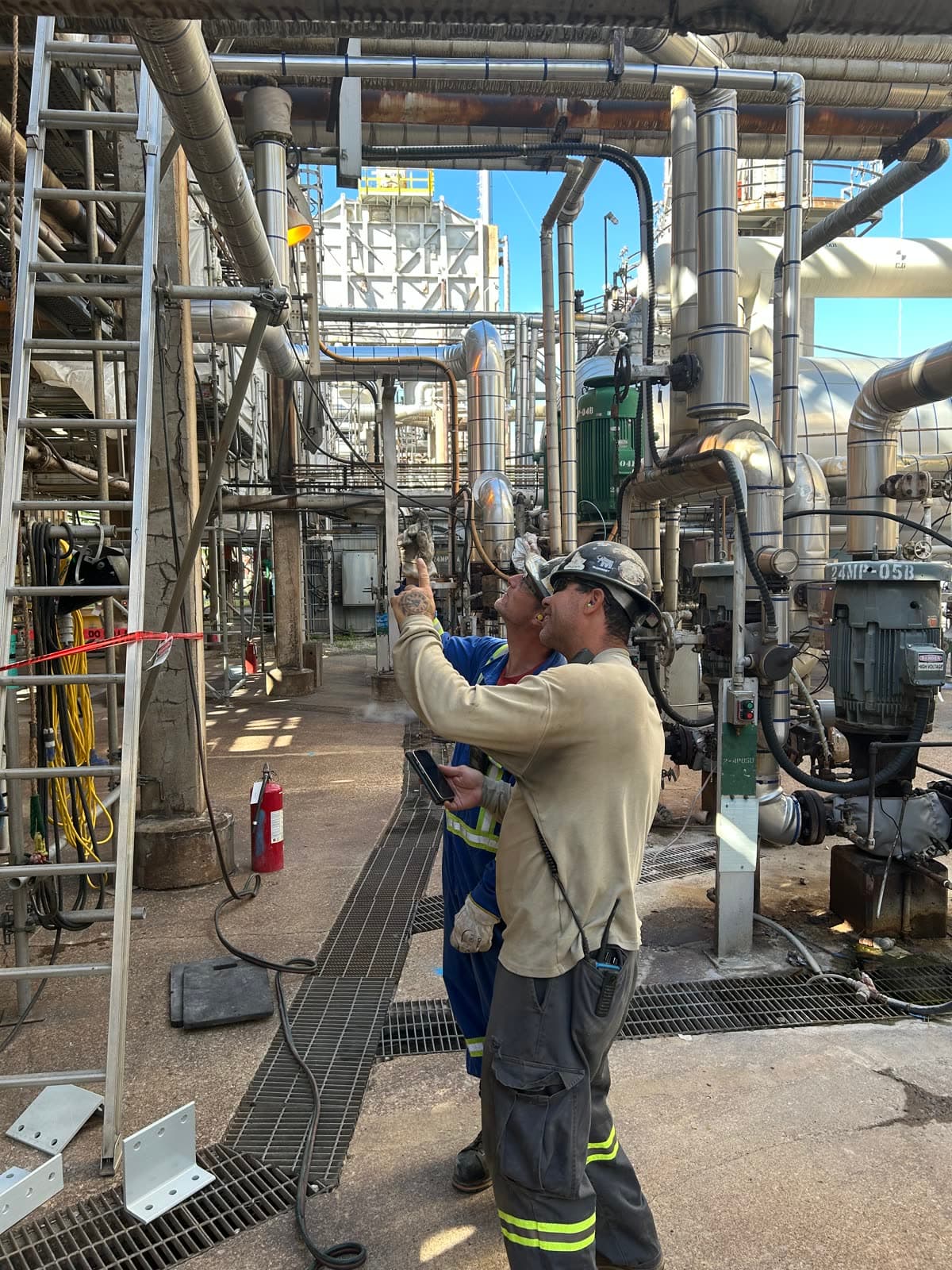 Crew reviewing a digital task card inside an operating unit
